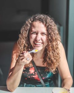 Woman with warm friendly smile eating